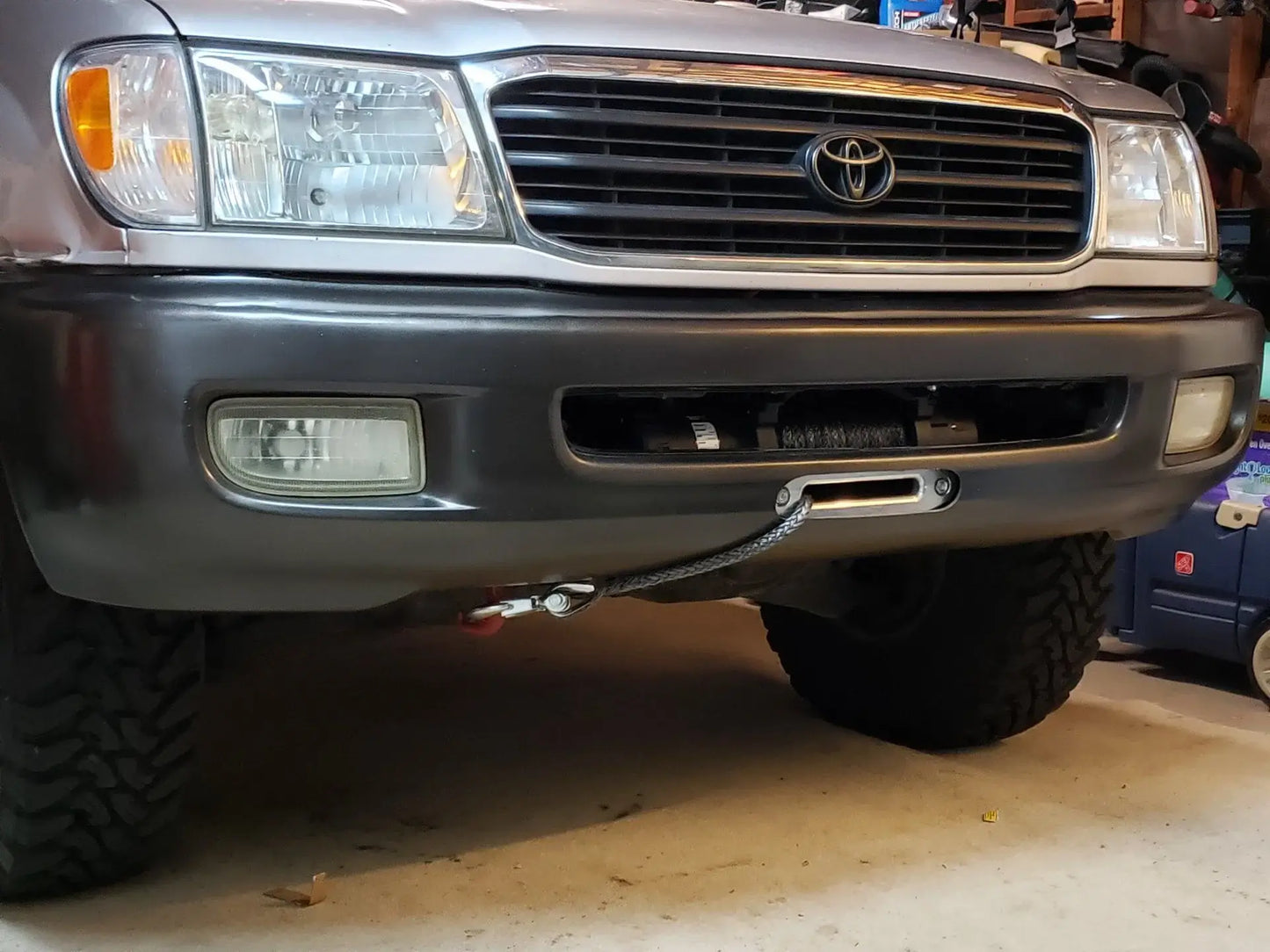 Toyota Land Cruiser 100 front bumper with hidden winch plate mount installed, heavy duty recovery accessory for off-road use