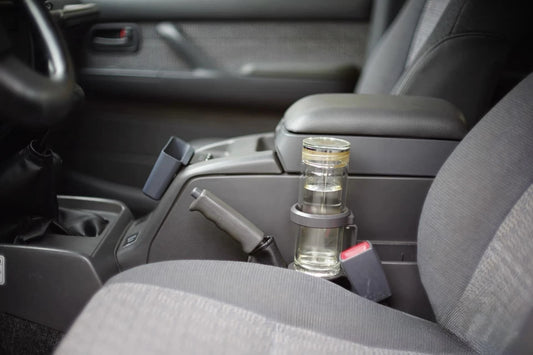 Toyota Land Cruiser 80 Series cup holder mounted on center console with glass bottle inserted