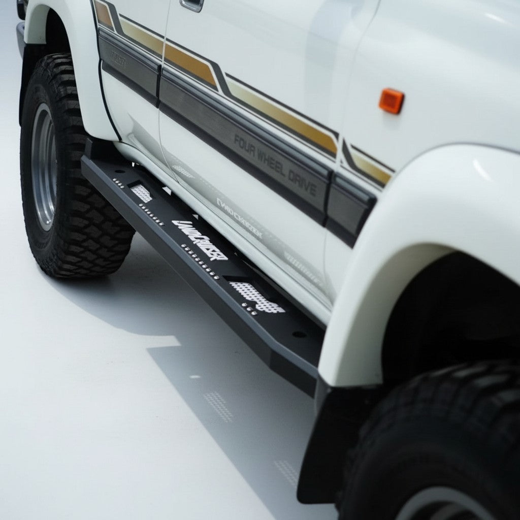 Ninja Cruiser custom aluminum rock slider side step for Toyota Land Cruiser 80 series with white "Land Cruiser" logo.