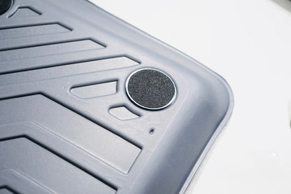 Close-up of a textured gray mat with a circular design on a white background