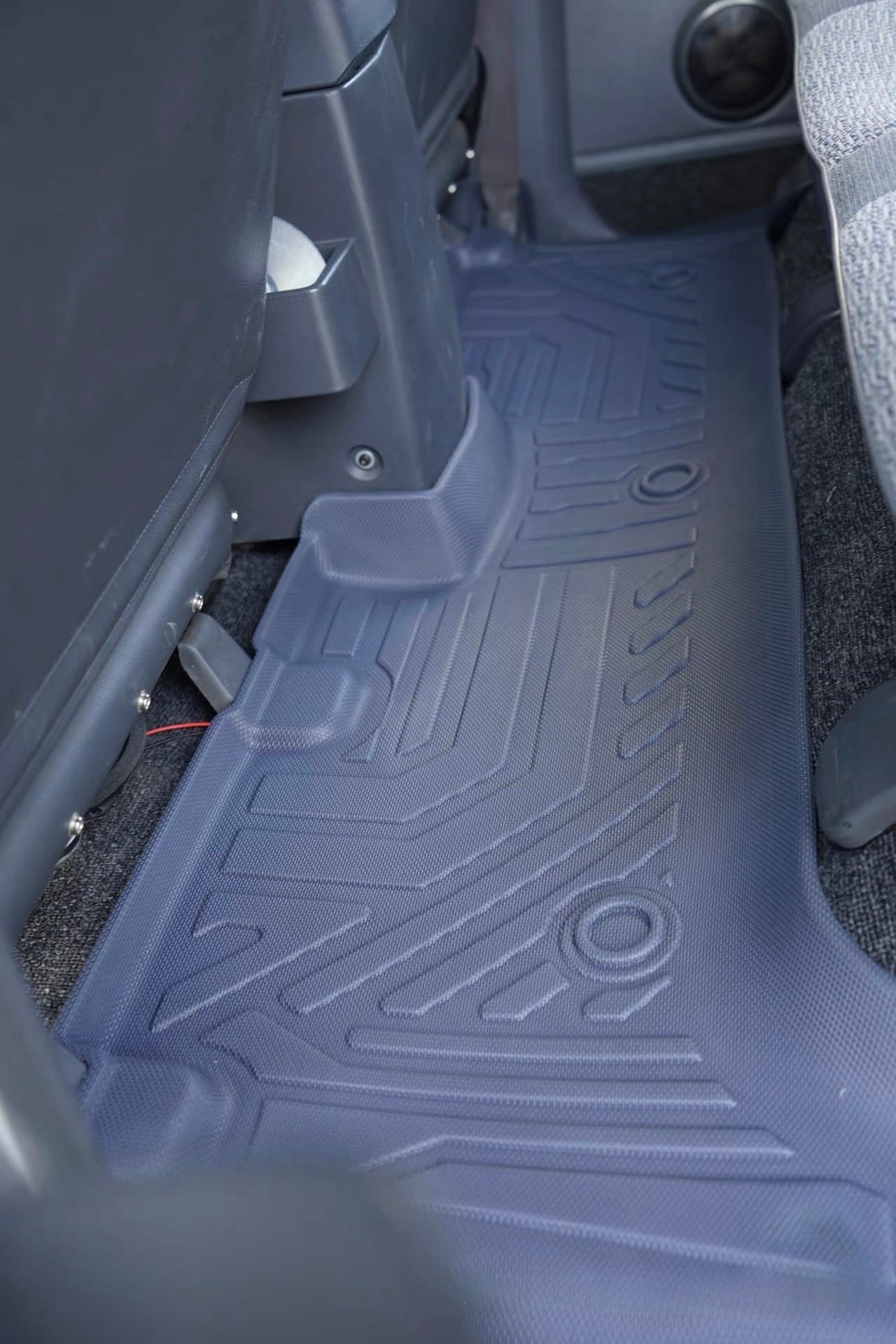 gray rear Car floor mat with geometric pattern on a vehicle interior