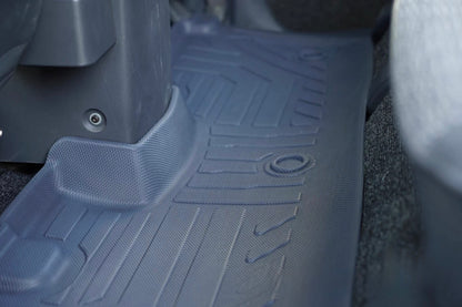 Close-up of a gray car floor mat with a detailed tread pattern