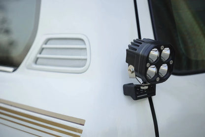 Toyota Land Cruiser 100 LED pod light mounted on rear window hinge bracket for off-road and camping use