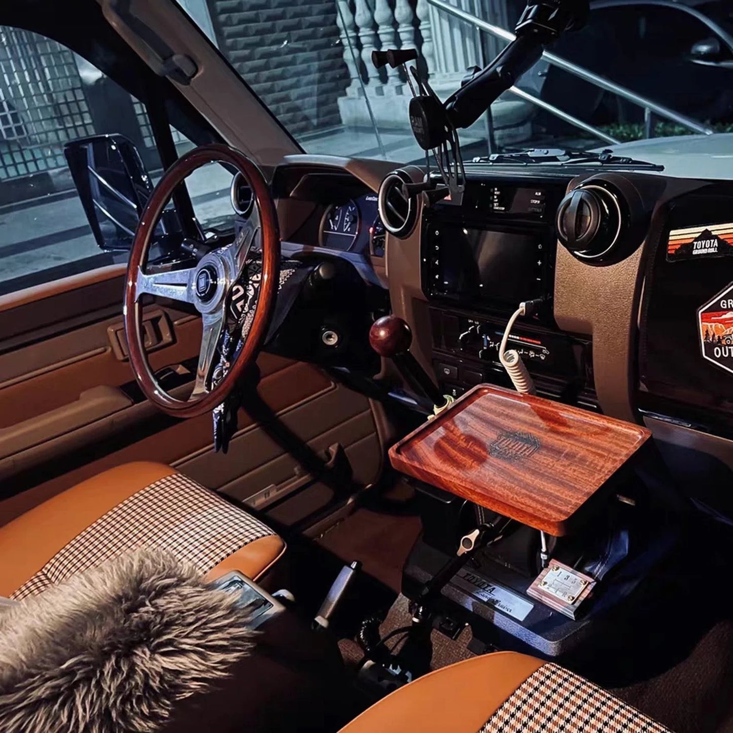 Luxury lc70 car interior with wooden dashboard and gear shift area.