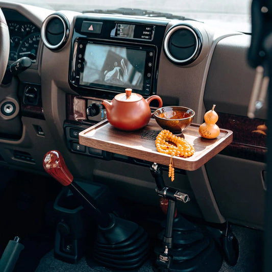 Land Cruiser 70 series 79 Wooden tray with teapot, bowl, and gourd on a car dashboard