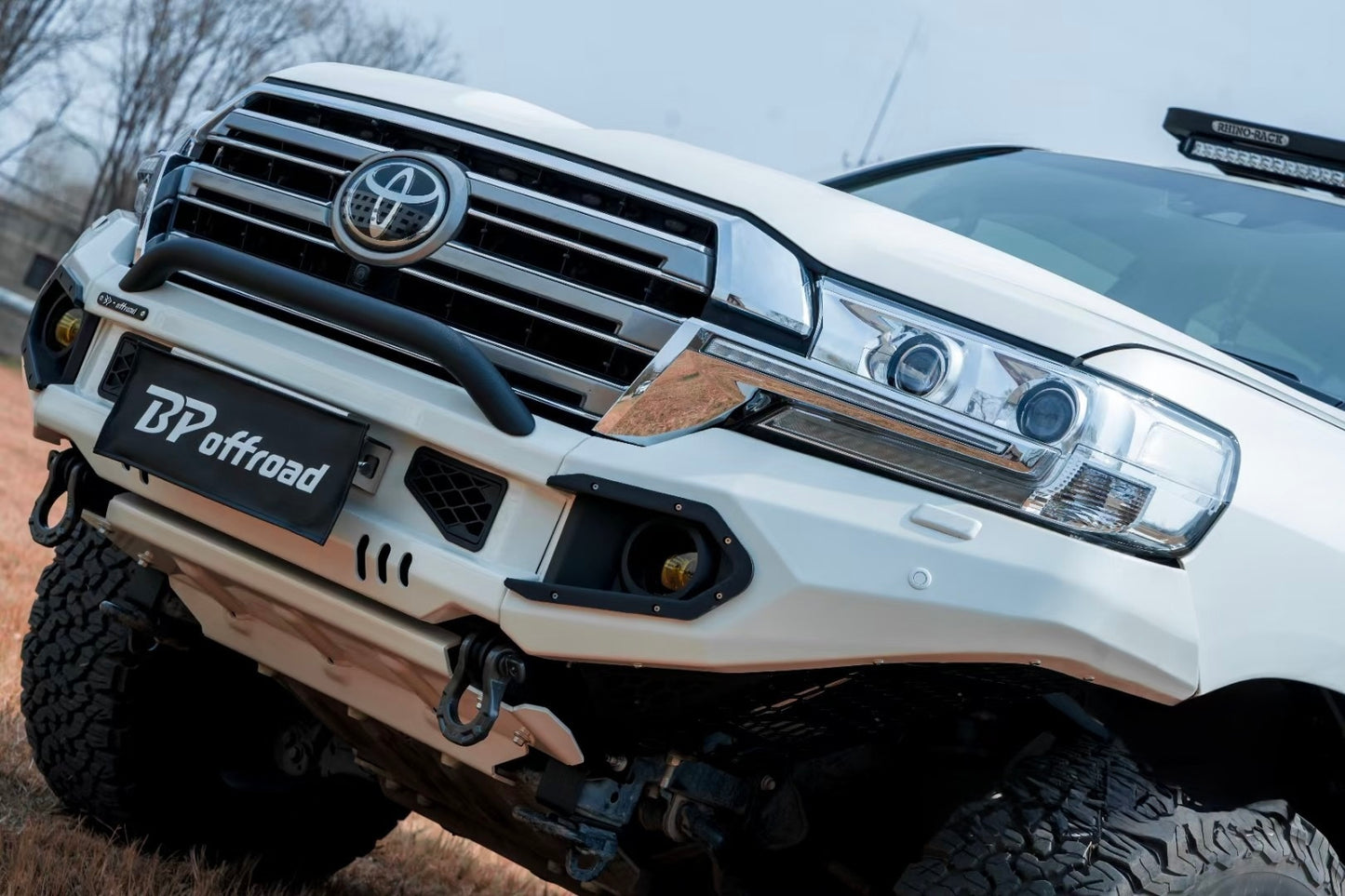Close-up of a Toyota lc200 facelift with a white BP Offroad bumper in an outdoor setting