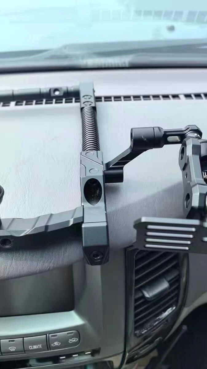 Close-up of a car's interior with a mounted camera and bracket installed on lx470 center dash
