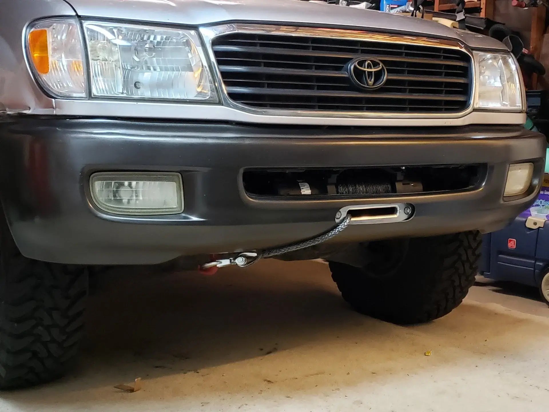 Toyota Land Cruiser 100 front bumper with hidden winch plate mount installed, heavy duty recovery accessory for off-road use