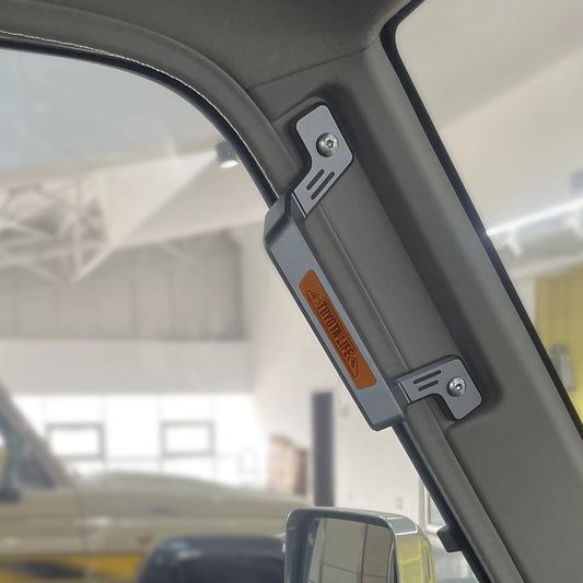 Land Cruiser 70 Series CNC Aluminum A-Pillar Grab Handle - Heavy-duty metal replacement handle installed on the front interior pillar, showcasing the silver-gray finish and "TOYOTALIFE" branding