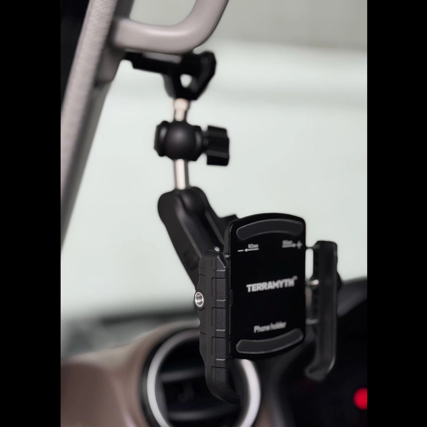 Land Cruiser 70 Series A-Pillar Action Camera Mount - Modular mounting system for Phone holder installed on the A-pillar grab handle of a Land Cruiser 70 Series, featuring the TERRAMYTH attachment