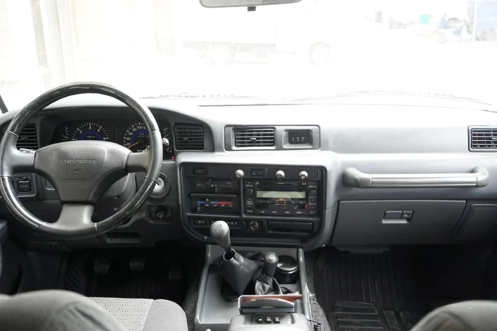 a wide rear view of interior of land cruiser 80 series dash with universal dash mount installed