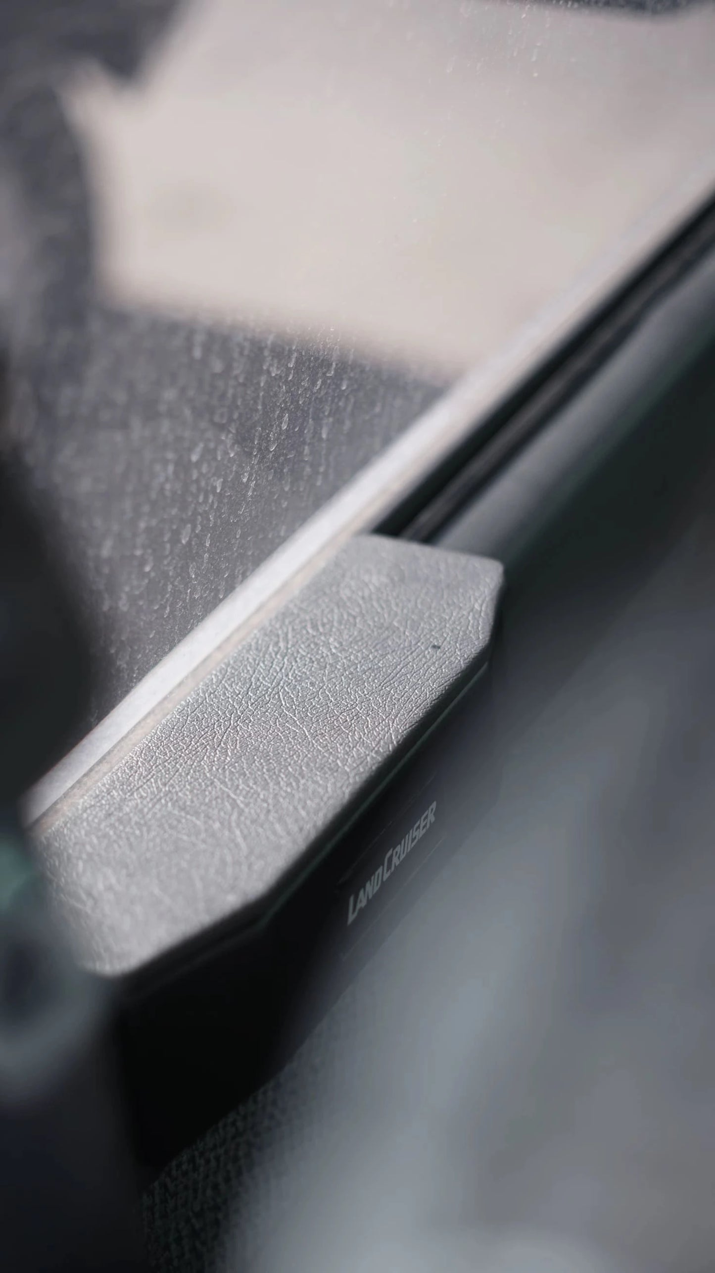 Close-up of Land Cruiser 80 series armrest pad showing surface texture