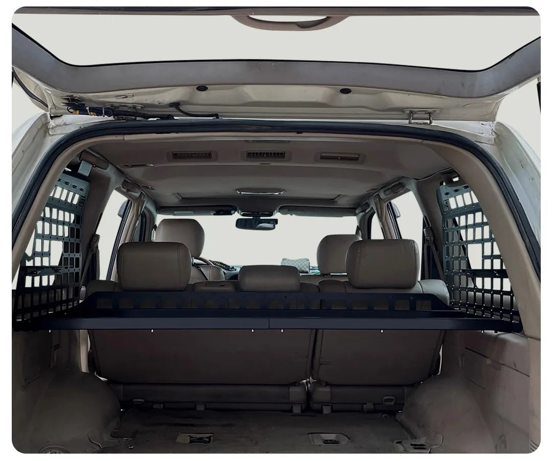 rear Interior view of Toyota Land Cruiser 100 or lexus lx470 with overhead MOLLE cargo shelf and side storage panels installed with single rack adjustable