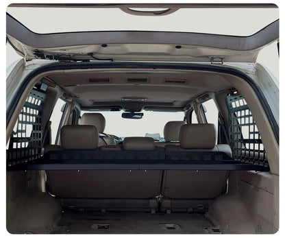 rear Interior view of Toyota Land Cruiser 100 or lexus lx470 with overhead MOLLE cargo shelf and side storage panels installed with single rack adjustable
