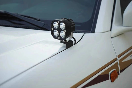 Ditch light bracket installed on Toyota Land Cruiser 100 Series hood with white led pod light
