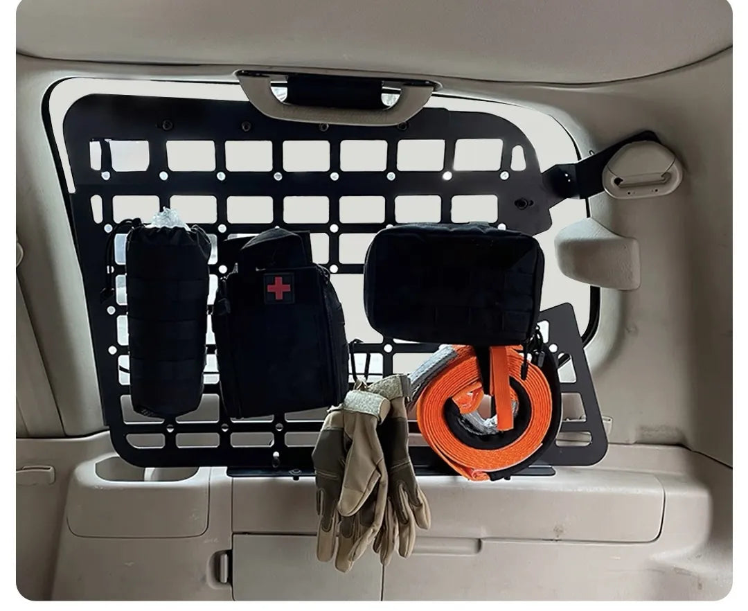 Lexus LX470 or toyota land cruiser 100 MOLLE panel with overland gear, first aid kit, gloves and recovery strap attached for off-road storage mounted on the rear side 3rd window panel