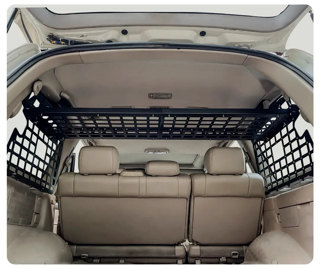 Interior view of Toyota Land Cruiser 100 or lexus lx470 with overhead MOLLE cargo shelf and side storage panels installed