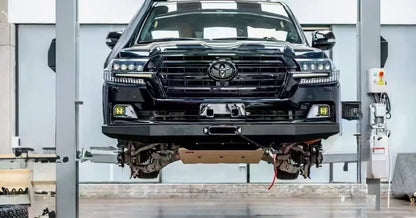Black facelift Toyota LC200 SUV on a lift in a workshop setting
