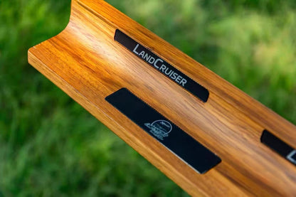 Wooden product with 'LandCruiser' branding on a blurred green background