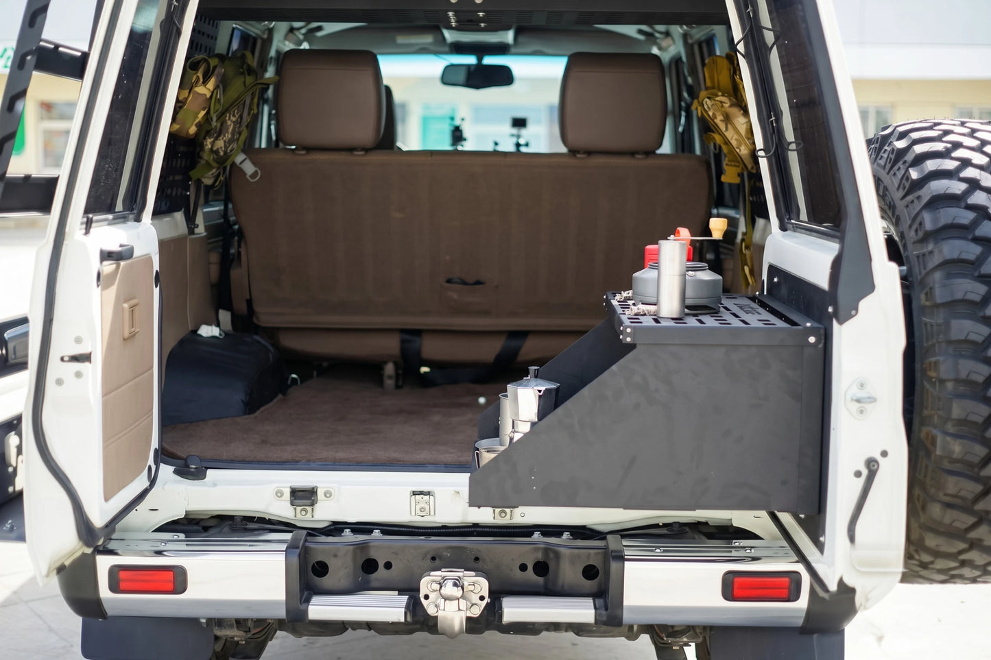 Land Cruiser 76 rear cargo drawer and fold-down camp table extended with cooking setup