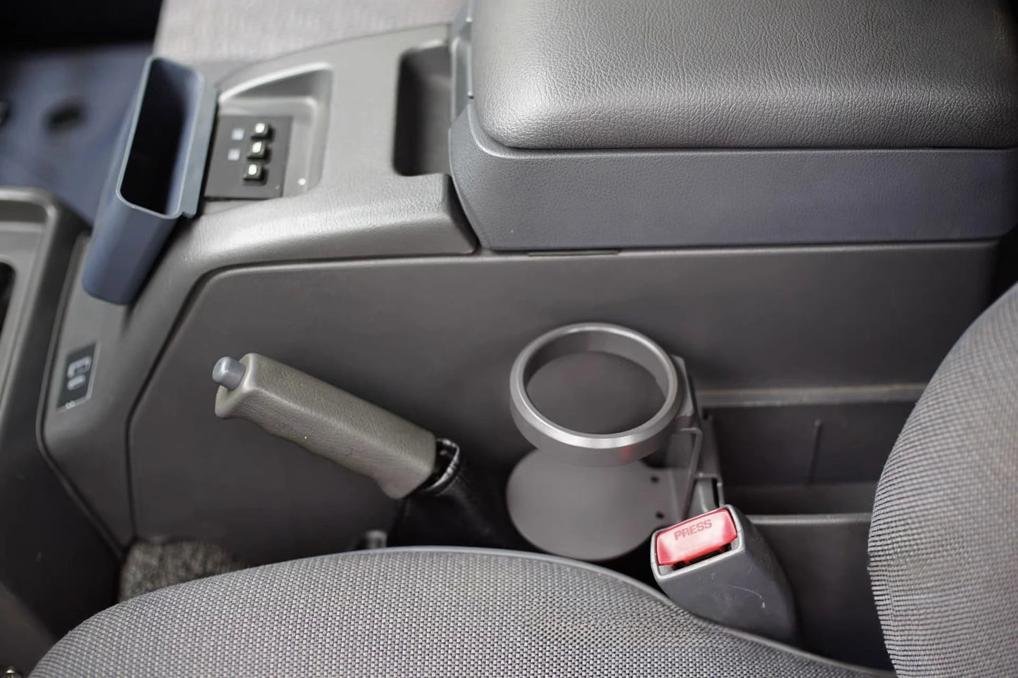 Empty center console cup holder installed in Toyota Land Cruiser 80 Series interior