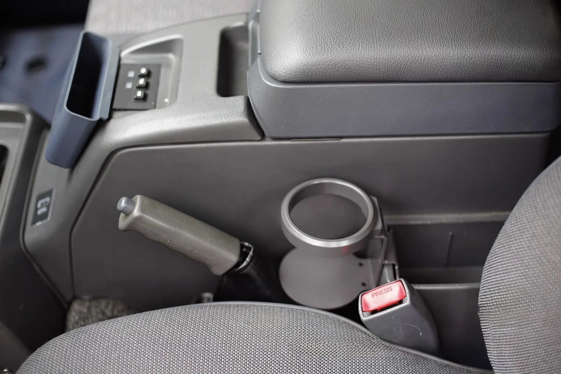 Empty center console cup holder installed in Toyota Land Cruiser 80 Series interior
