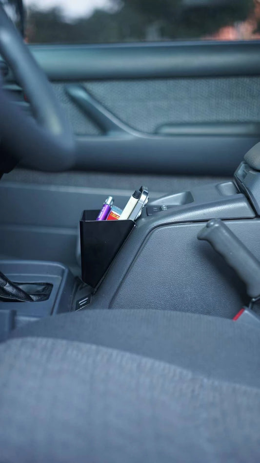 Toyota Land Cruiser 80 Series center console storage box with phone, pens, and accessories – black ABS plastic insert