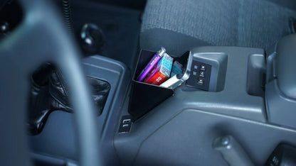 Toyota Land Cruiser 80 Series interior organizer box installed beside handbrake – holds phone, pens, and accessories securely