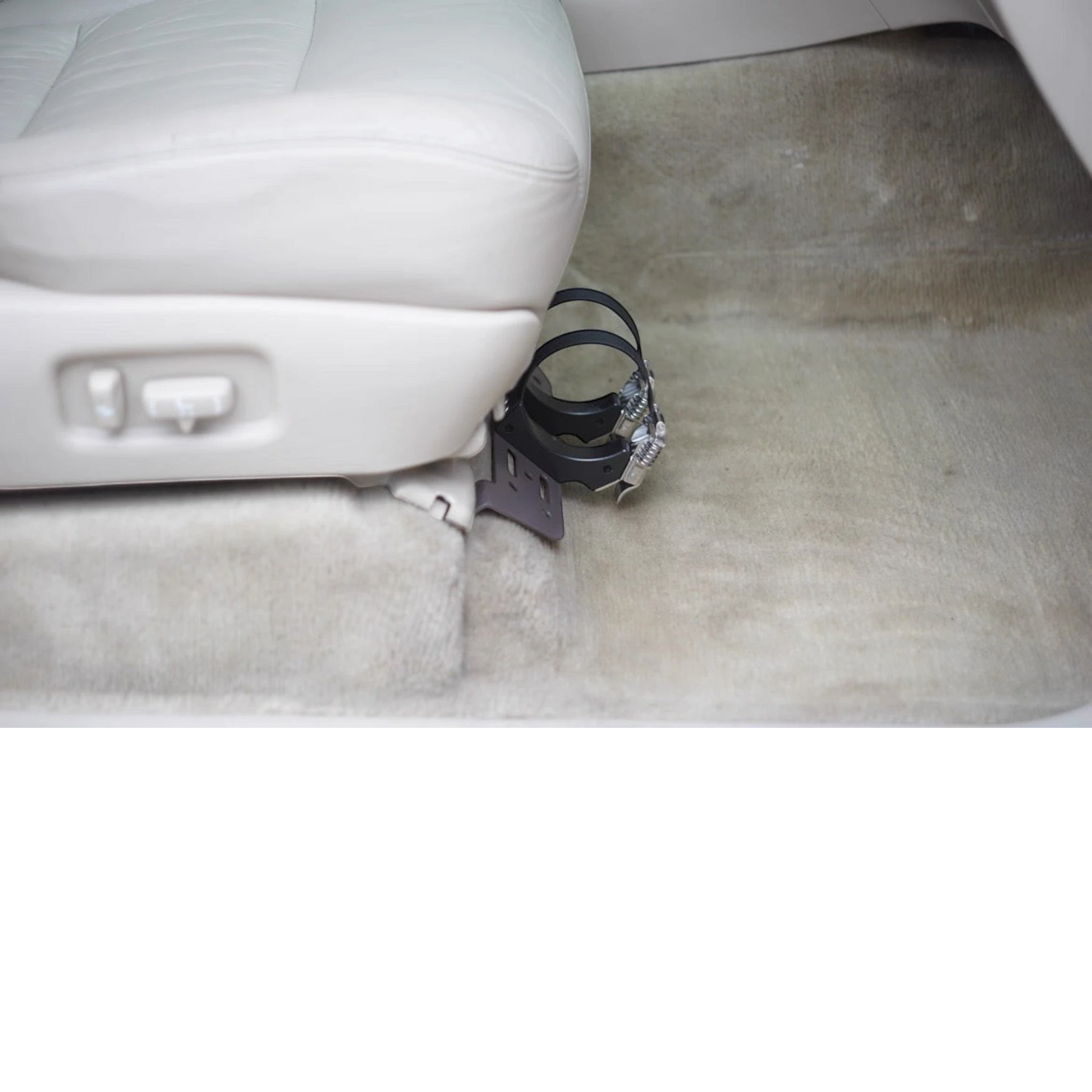 Ninja Cruiser black steel fire extinguisher bracket mounted under the passenger seat of a Toyota Land Cruiser 100 Series.