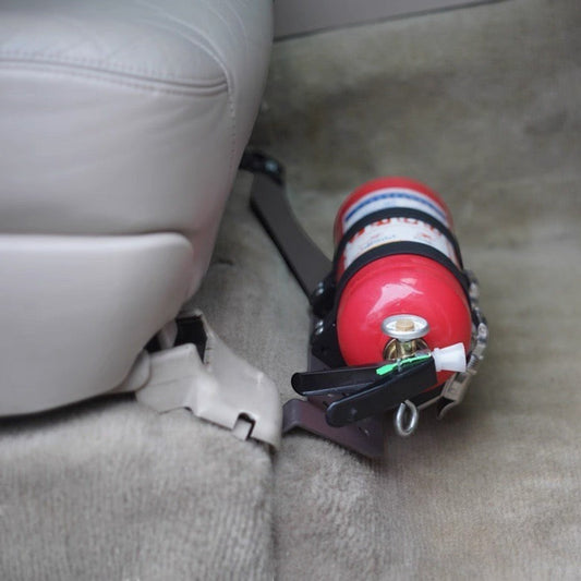 Ninja Cruiser LC100 fire extinguisher bracket mounted under passenger seat of Toyota Land Cruiser 100 Series.