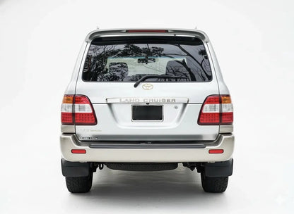 Ninja Cruiser LED tail lights for Toyota Land Cruiser 100 Series (2003-2007) with clear lenses and red/amber LEDs.
