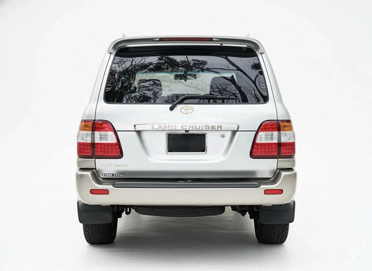 Ninja Cruiser LED tail lights for Toyota Land Cruiser 100 Series (2003-2007) with clear lenses and red/amber LEDs.