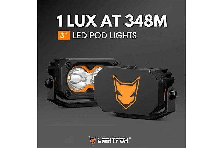 Ninja Cruiser black steel 3-inch LIGHTFOX LED pod lights with orange accents, designed for off-roading.