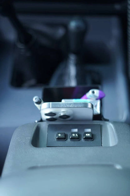 Ninja Cruiser matte black ABS plastic center console organizer tray for Toyota Land Cruiser 80 Series (1990-1997) with phone and earbuds.