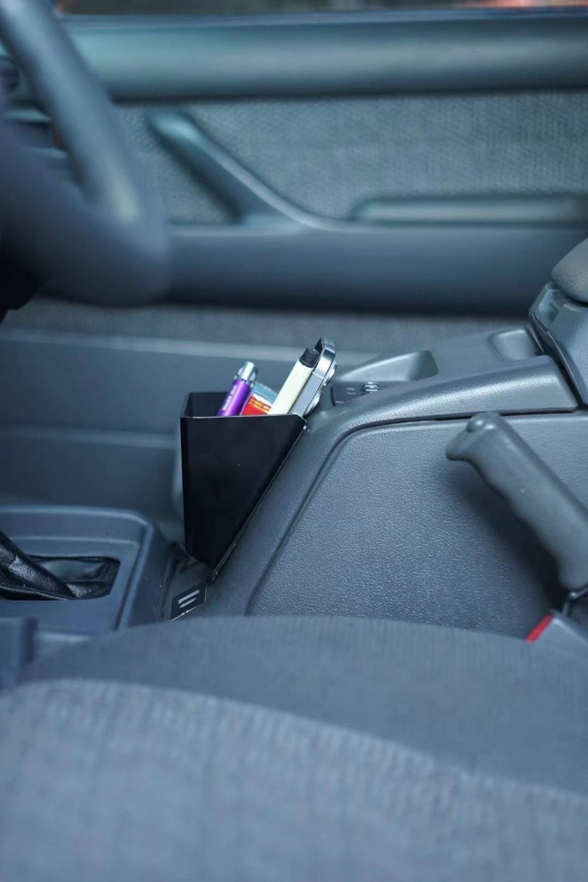 Ninja Cruiser matte black ABS plastic center console organizer tray for Toyota Land Cruiser 80 (1990-1997) with cup holder and phone tray.