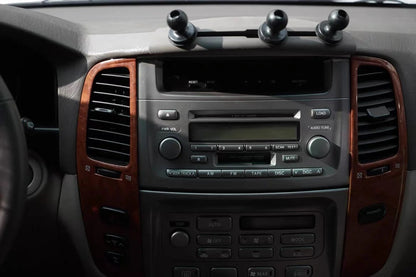 Ninja Cruiser dashboard expansion mount with three ball joints for 2004-2007 Land Cruiser 100/Lexus LX470. Dark grey ABS plastic.