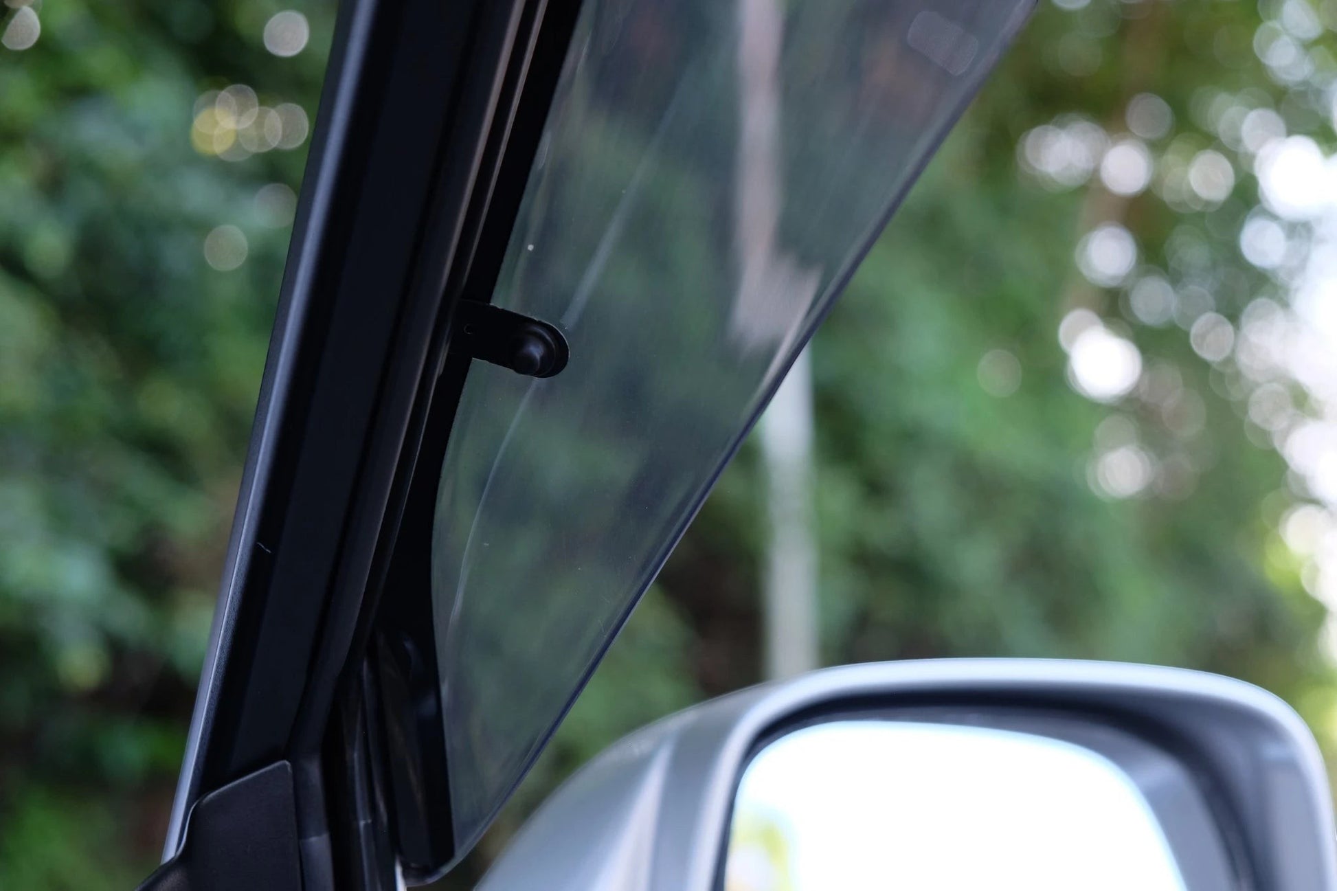 Ninja Cruiser Genuine JDM Toyota Land Cruiser 100 Series window visor, clear acrylic with black trim, for rain and airflow.