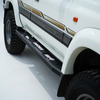 Ninja Cruiser custom aluminum rock slider side step for Toyota Land Cruiser 80 series with white "Land Cruiser" logo.