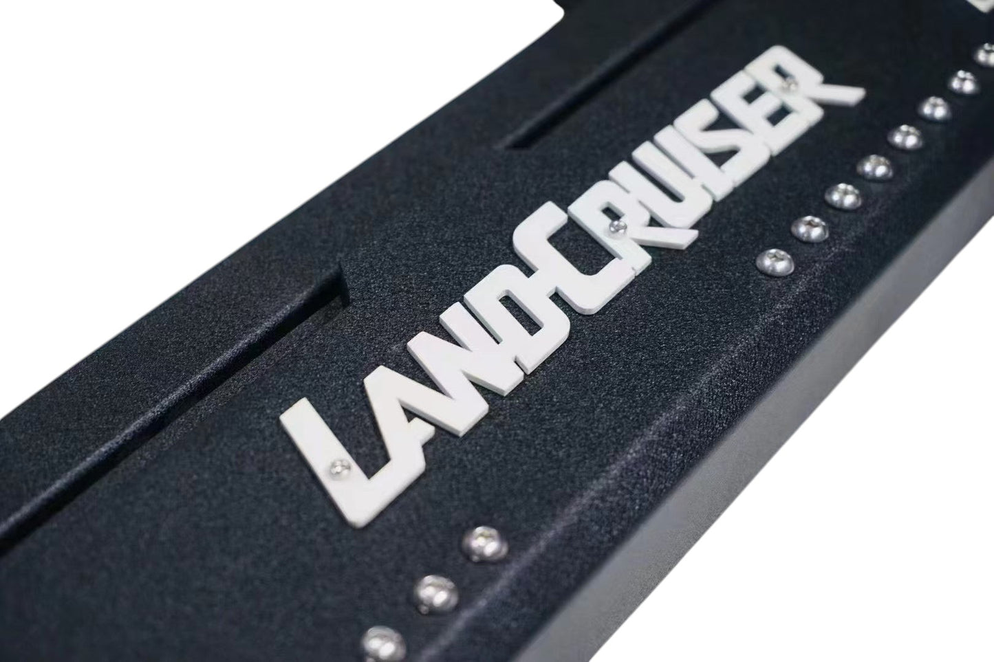 Ninja Cruiser custom black aluminum rock slider side step with white "Land Cruiser" logo for Toyota Land Cruiser 80 series.