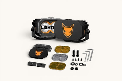 Ninja Cruiser LC100 Front Ditch Light Brackets and Lightfox LED pods led light package including two black brackets, clear and amber lenses, and hardware.