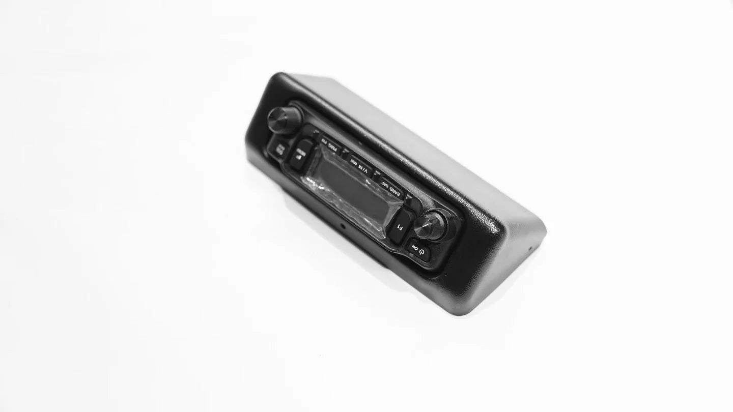 Precision ABS plastic radio bracket for LC100 overhead console mounting.