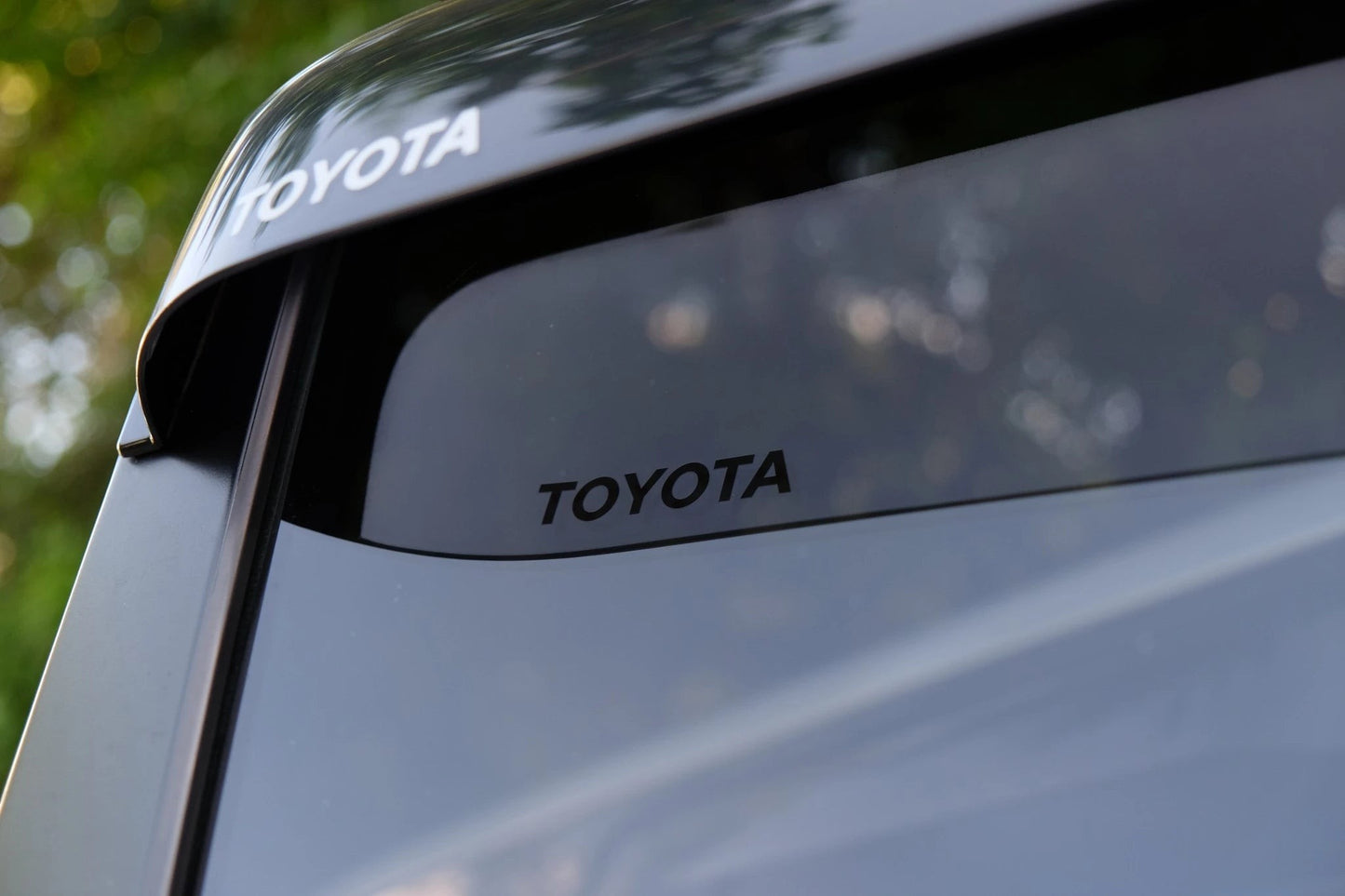 Ninja Cruiser Genuine Toyota JDM window visors for Land Cruiser 100 Series & LX470. Dark tinted acrylic rain guards.