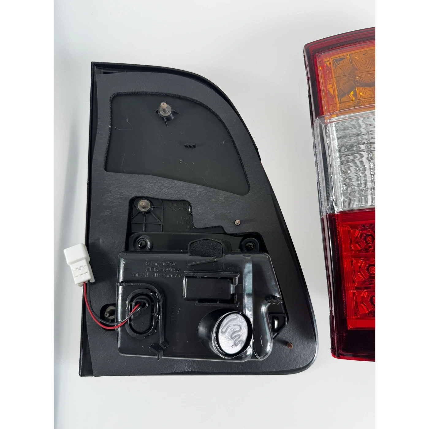 Ninja Cruiser LED tail light for Toyota Land Cruiser 100 Series (2003-2007). Features clear, red, and amber sections with modern LED array.