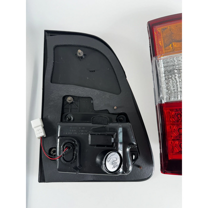 Ninja Cruiser LED tail light for Toyota Land Cruiser 100 Series (2003-2007). Features clear, red, and amber sections with modern LED array.