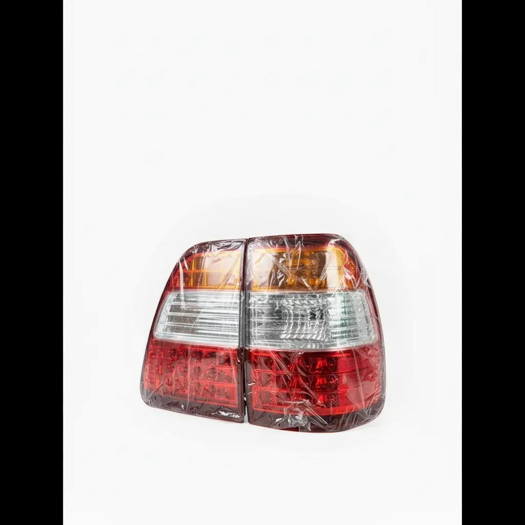 Ninja Cruiser LED tail lights for Toyota Land Cruiser 100 Series (2003-2007). Red and clear lenses with modern LED pattern.