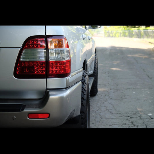 Ninja Cruiser LED tail lights for Toyota Land Cruiser 100 Series (2003-2007). Clear lens with red and white LED sections.