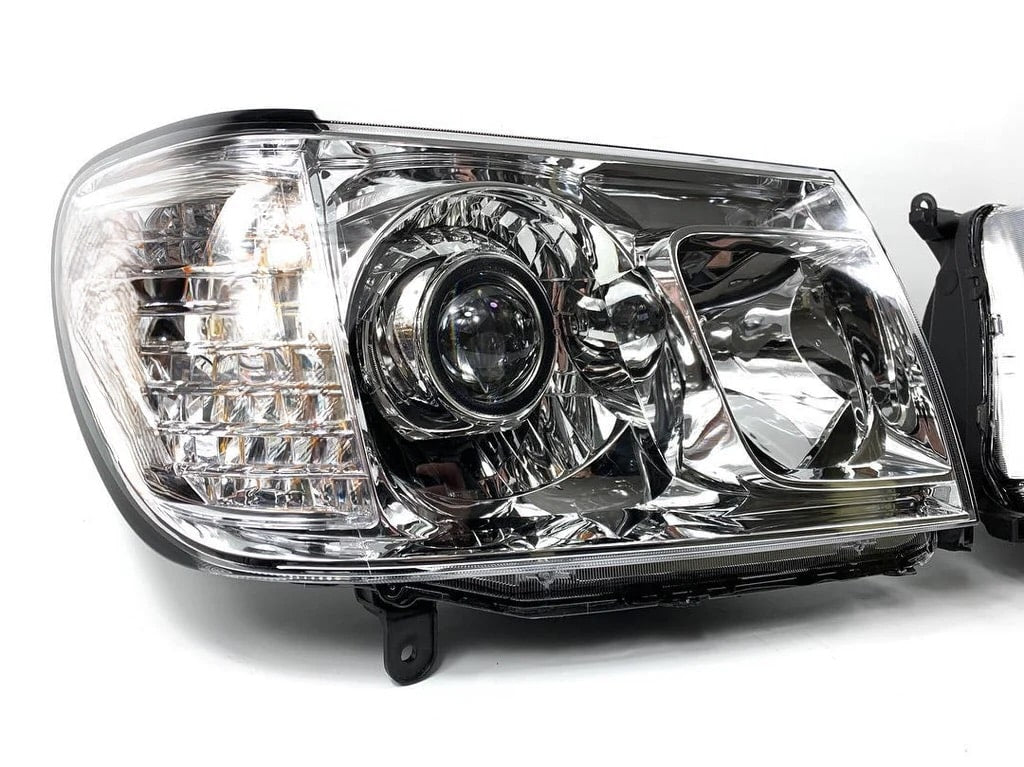 Car LC100 Land Cruiser front left headlight projector LED on a white background