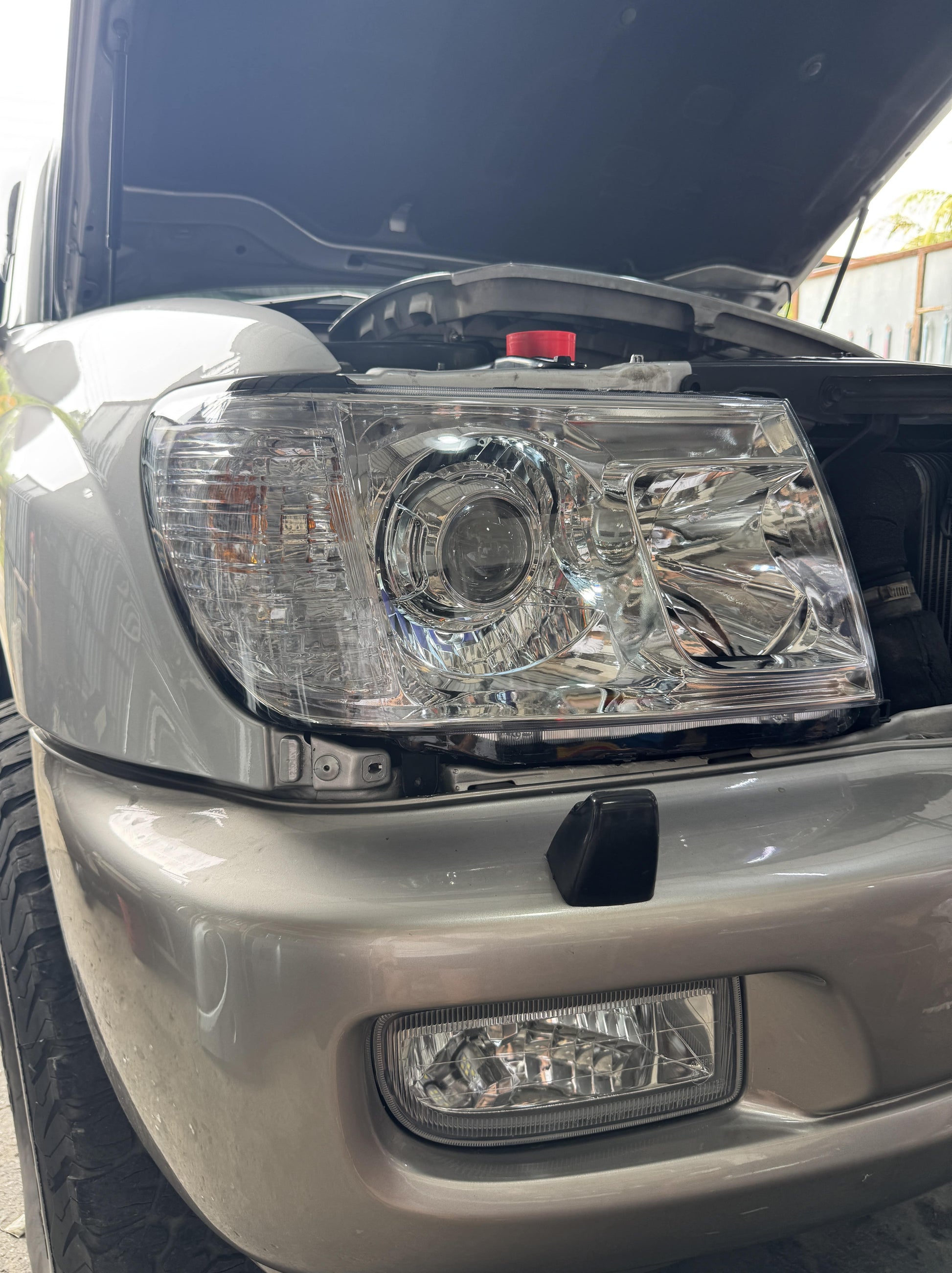 Close-up of a car LC100 front projector led headlight installation