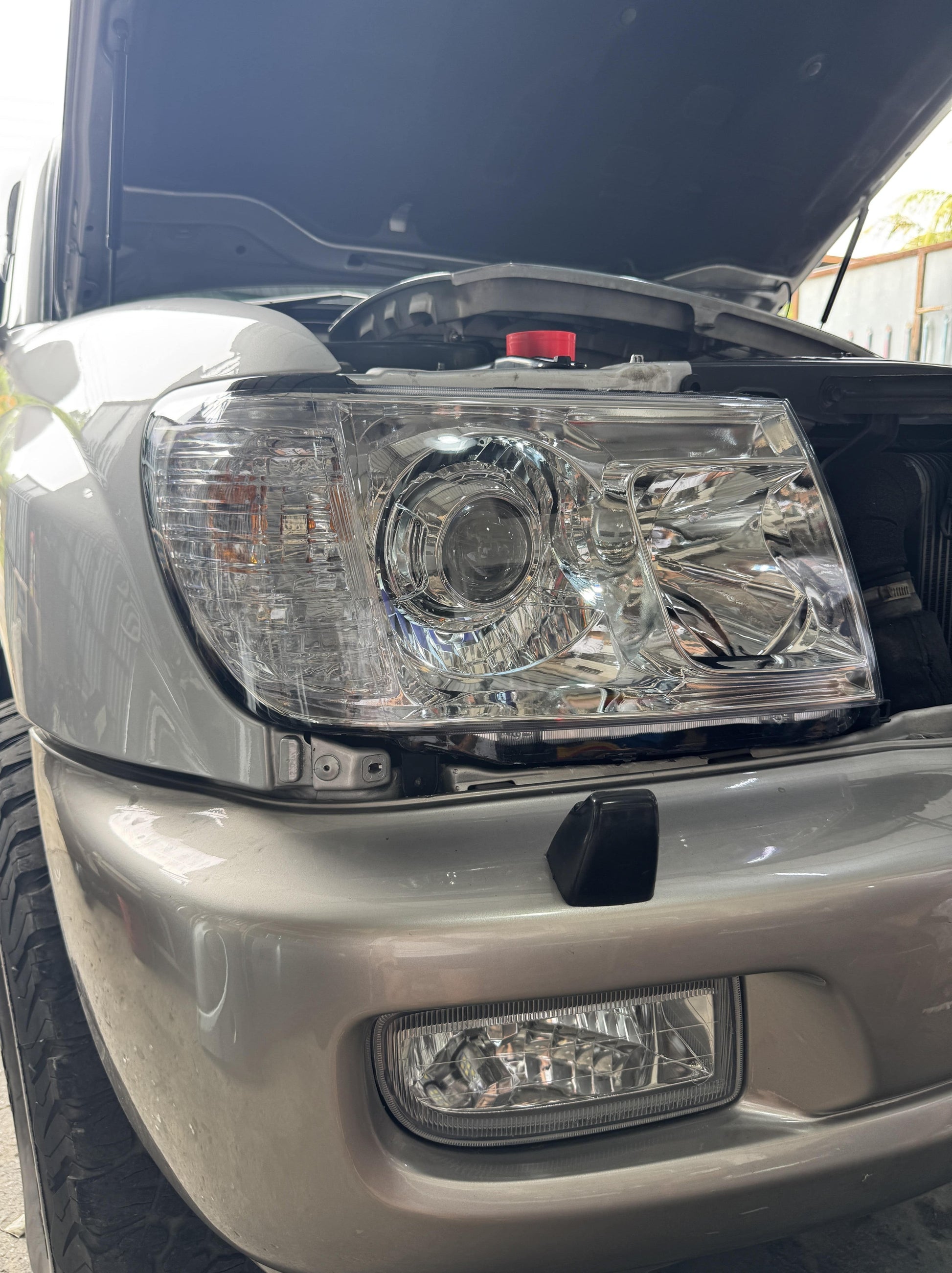 Close-up of a car LC100 front projector led headlight installation