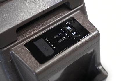 Toyota Land Cruiser 70 Series centre console fridge control panel showing power, temperature and cooling settings in brown